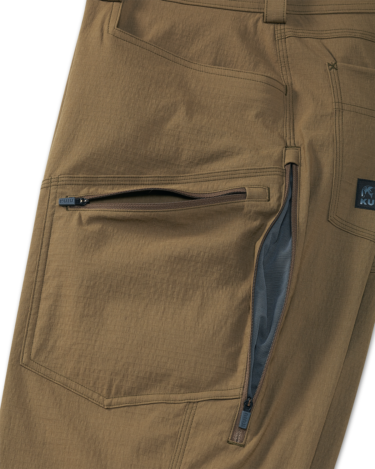 Close-up detail of front thigh zippered pocket and hip-zips with lightweight mesh lining for ventilation on the Groundwork Stretch Woven Pant in Tobacco Brown
